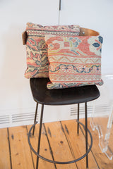Mahal rug pillow's lower edge with geometric pattern and rich red velvet trim.