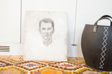 Bottom edge of the vintage pencil sketch of a man, with light discoloration.