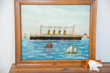 Close up of the Titanic's bow and name on Milton Bond's vintage reverse glass painting.