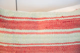 Faded pink-red and green striped Moroccan Kilim pillow texture.