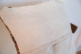 Throw pillow back featuring light gray corduroy and envelope closure.