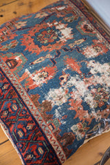 Antique Lilihan floor pillow displaying vivid blue, red, and green pattern with storied texture and border.