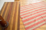 Coral and light beige striped vintage Moroccan kilim rug with flatweave texture and fringed wider edges.