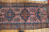Vintage Malayer runner, blush rose field, blue abrashes, tribal motifs, and worn ends.