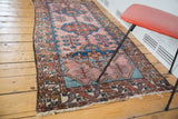 Tattered fringe and rectilinear tribal patterns on the end of the vintage Malayer runner.