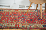 Vintage Malayer runner's cherry red field, geometric herati motif, and ivory crab style border.