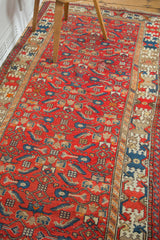 Vintage Malayer runner, cherry red field with geometric herati and ivory crab style border.