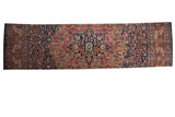Finely knotted Farahan Sarouk runner with vibrant rose, blue, and green floral medallion.