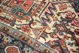 Ivory Heriz corner spandrel with meandering samovar motifs, vibrant blues, reds, and distressed texture.