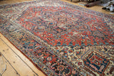 Vintage Heriz border showcasing samovar motifs with distressed field texture.