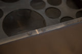 Circular bottle compartments, subtle hardware, and patina on antique bar.