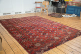 Antique Tekke Bokhara rug, repeating gul motifs across a rich madder red field.