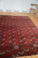 Antique Tekke Bokhara rug detail: varied gul motifs in madder red, navy, and green.