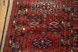 Antique Tekke Bokhara rug detail: madder red field, geometric guls, unique alternating border.
