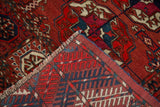 Finely hand-knotted reverse and pile showcasing gul motifs in madder red, navy, ivory.