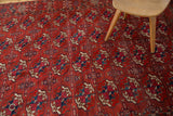 Antique Tekke Bokhara rug's repeating gul motifs with alternating mallard green and navy blue.