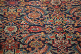 Intricate herati motif in jewel red, sky blue, and saffron on an antique Persian Malayer runner.