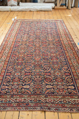 Hand-knotted herati motif in brilliant jewel tones on the antique Malayer runner's indigo field.