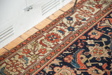 Distressed Antique Malayer rug border: splayed florals on beige, contrasting navy field.