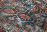 Detailed distressed Bakhtiari pattern with hexagonal indigo, madder red, and peach hues.