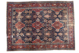 Distressed Bibikabad Persian carpet, bold cherry red and navy blue medallion design.
