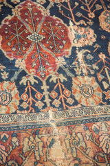 Distressed vintage Bibikabad rug: worn texture with decorative navy, cherry red, and faded peach.