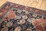 Distressed vintage Bibikabad carpet showing bold navy, cherry red palmette rendering.
