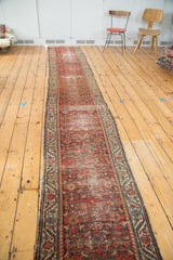 Antique Distressed Hamadan runner showing repeated brick red herati motif and weathered texture.