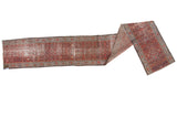 Extended view of antique distressed Hamadan runner with brick red herati patterns and worn sections.
