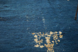 Distressed cobalt blue pile with beige floral vase motif on antique Chinese Peking rug.