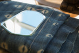 Top curve of Art Deco bell shape beveled mirror with copper wire.