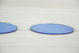 Detail of the oval Art Deco blue glass mirror, highlighting its smooth edge.