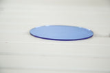 Edge of the vintage Art Deco blue oval glass mirror, highlighting its color depth.