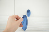Small vintage Art Deco blue oval glass mirror, held by hand.