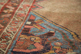 Distressed antique Halvai Bijar rug, showcasing fine geometric weave, aqua, blush, and camel hues.