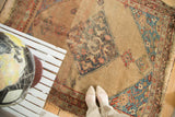 Antique Halvei Bijar rug's distressed camel field, expressive dark blue medallion corner, and aqua border.