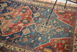 Distressed texture and tribal animal figures on indigo blue field.