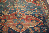 Antique Seichor Kuba rug detail: geometric animal motif, distressed indigo and cherry red palette.