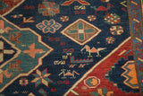 Distressed antique Seichor Kuba rug featuring stylized animal figures and vibrant geometric patterns.