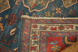 Distressed indigo blue field, red geometric border, and fringe on an Antique Kuba rug.