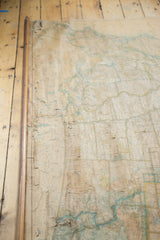 Cracked, time-softened surface of the vintage 1941 USA pull-down map and wooden dowel.