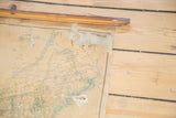 Close-up of the vintage USA pull down map's frayed upper edge and wooden dowel.