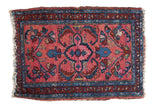 Distressed Lilihan rug mat, deep blush rose field with mirrored floral design, blue borders.