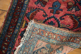 Tattered fringe, distressed red and blue Lilihan rug pile, and hand-knotted reverse.