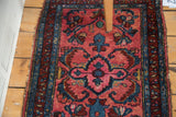 Decorative distressed Lilihan rug with blush rose medallion and serrated blue leaves.
