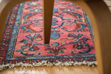 Distressed Persian Lilihan rug mat with tattered fringe and rose, blue floral motifs.