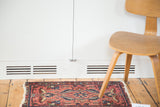 Vintage Lilihan rug with distressed blush rose field and intricate scrolling vine motifs.