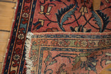 Distressed Lilihan rug showing tattered selvage, woven wefts, and blush rose floral design.