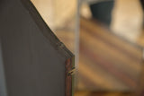 Antique tri-folding mirror's dark wooden backing edge with fantastic patina and metal hinge.