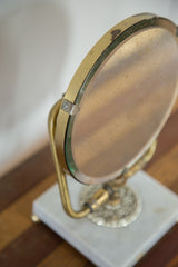 Mid Century Hollywood mirror showing beveled brass frame and discolored glass.